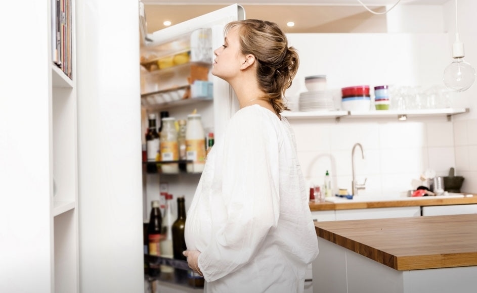 Woman facing the fridge