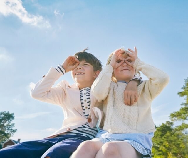 Two children looking at the sky