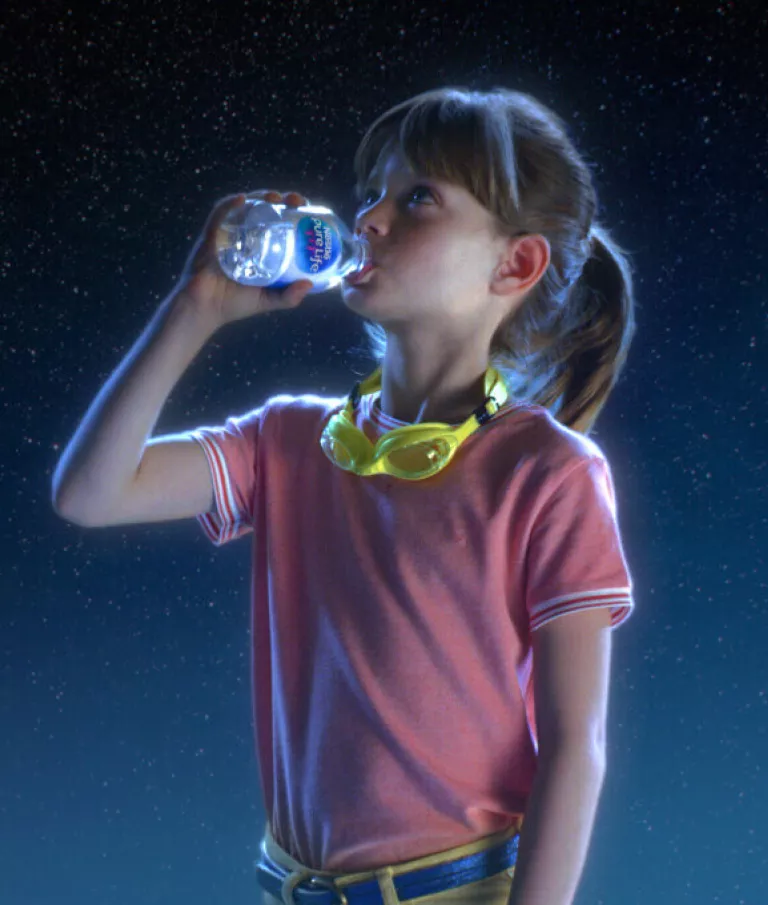 girl drinking an 8 oz mini bottle of nestle pure life purified water