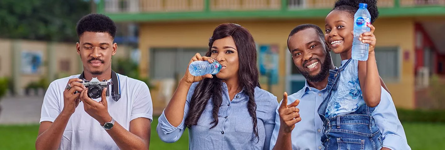 A Family drinking Nestle Pure Life Premium drinking water outdoor