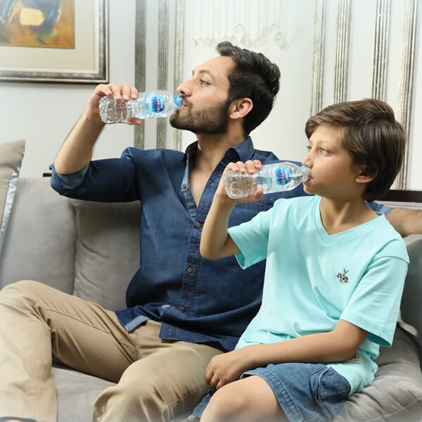 Family drinking Nestlé® Pure Life®