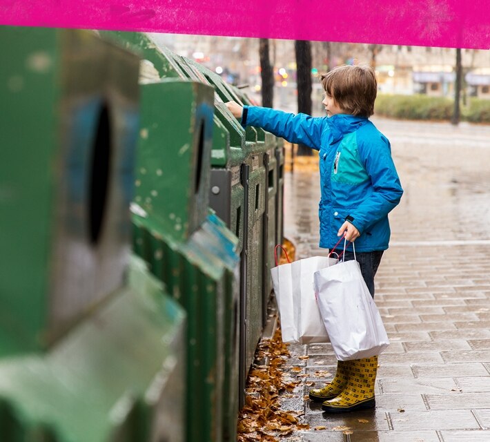 nestle pure life little boy using a green recycling bin