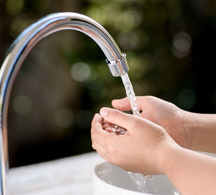 nestle pure life washing hands from the tap