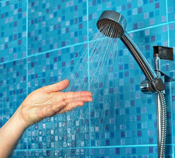 nestle pure life wasing hand in the shower