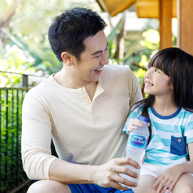 Family drinking Nestlé® Pure Life®