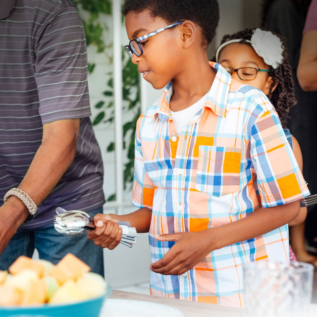 Children helping adults set the table