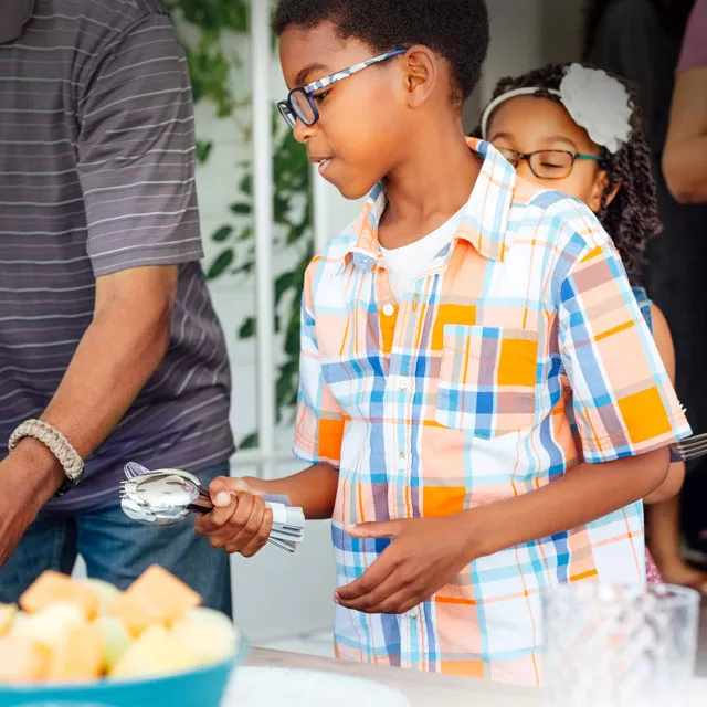 Children helping adults set the table