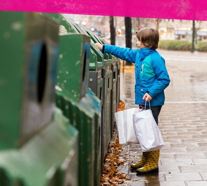 nestle pure life little boy using a green recycling bin