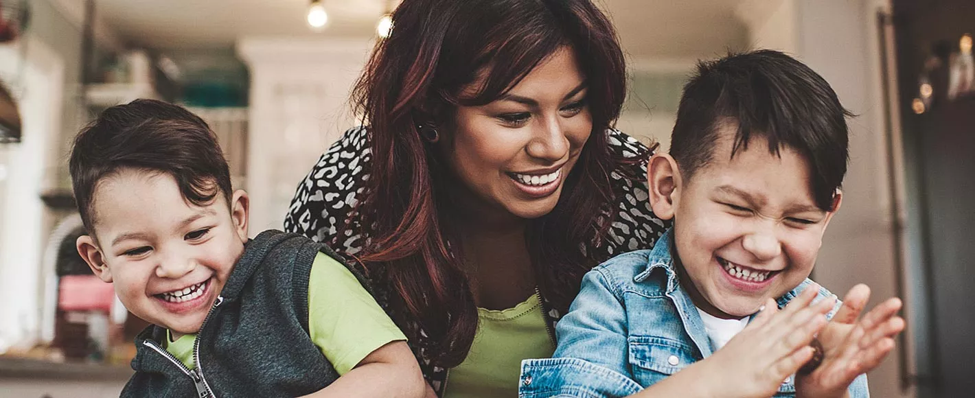 Mum and 2 boys kids playing happily