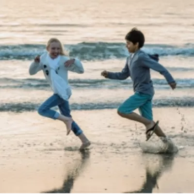 Man and woman are running on the beach